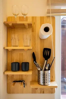 a kitchen with wooden shelves with utensils at Emir Hotel in Istanbul