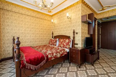 a bedroom with a bed and a television in it at The First Ottoman Apartments in Istanbul
