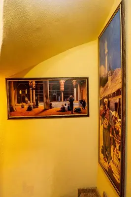 a picture on a wall with a painting on it at The First Ottoman Apartments in Istanbul