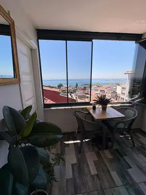 a room with a table and chairs and large windows at Peker Hotel in Istanbul
