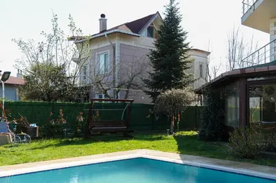 a house with a swimming pool in front of a house at Villa Moon in Gebze