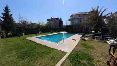 a swimming pool in the yard of a house at Villa Moon in Gebze