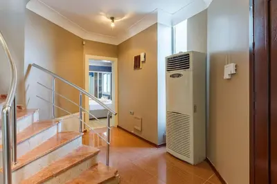 a hallway with stairs and a refrigerator in a house at Villa Moon in Gebze