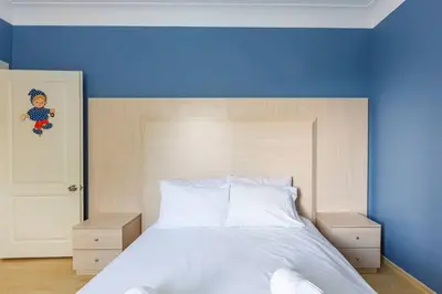 a bedroom with a large bed with a blue wall at Villa Moon in Gebze
