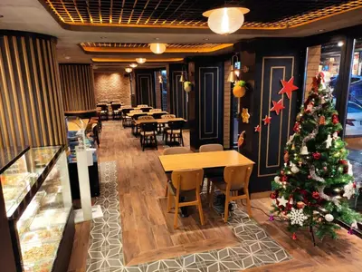 a christmas tree in a restaurant with tables and chairs at Delta Hotel Istanbul & Old City in Istanbul