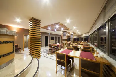 a restaurant with tables and chairs in a room at Delta Hotel Istanbul & Old City in Istanbul