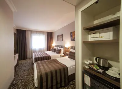 a hotel room with two beds and a window at Delta Hotel Istanbul & Old City in Istanbul