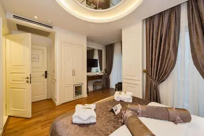 a bedroom with a large bed with white towels on it at Darkmen Hotel 2 in Istanbul