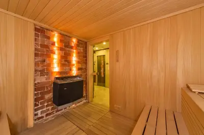 a room with a television and a brick wall at Darkmen Hotel 2 in Istanbul