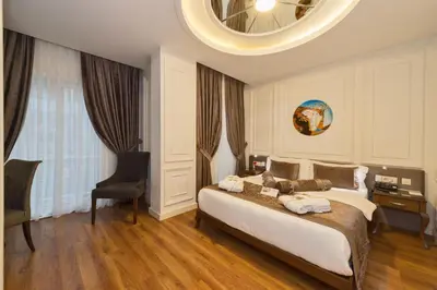 a bedroom with a bed and a chair and a mirror at Darkmen Hotel 2 in Istanbul
