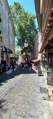 a cobblestone street with people walking on it at Coskun House in Istanbul
