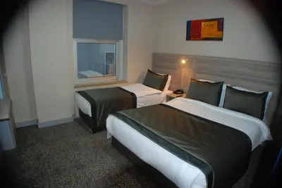a hotel room with two beds and a window at Sinem Hotel & Old City in Istanbul