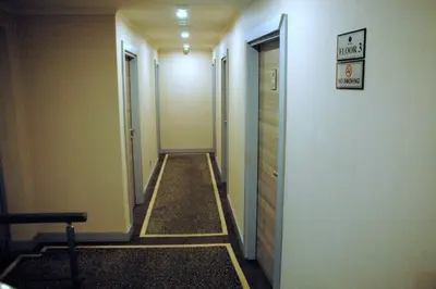a long hallway with a sign on the wall and a sign on a door at Sinem Hotel & Old City in Istanbul