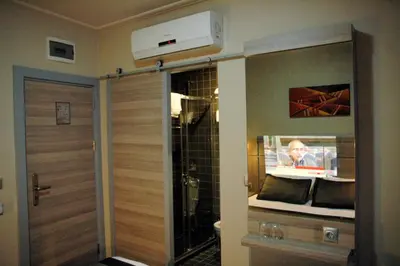 a bathroom with a shower and a door with aperature at Sinem Hotel & Old City in Istanbul
