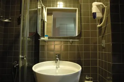 a bathroom with a sink and a mirror at Sinem Hotel & Old City in Istanbul