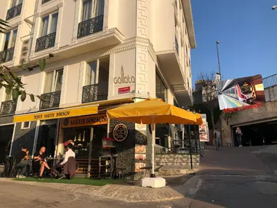 a restaurant with an umbrella in front of a building at Galata istanbul Hotel in Istanbul