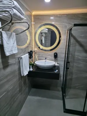 a bathroom with a sink and a mirror at Gardan Hotel in Beylikduzu