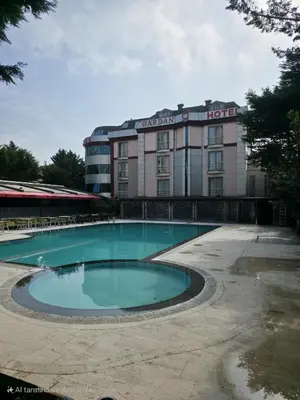a hotel with a swimming pool in front of a building at Gardan Hotel in Beylikduzu