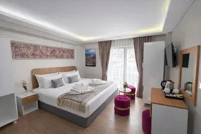 a hotel room with a bed and a television at Ria Suites Boutique Hotel in Istanbul