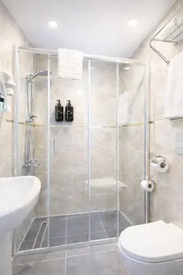 a bathroom with a shower with a toilet and a sink at Ria Suites Boutique Hotel in Istanbul