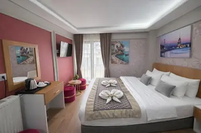 a hotel room with a large bed with flowers on it at Ria Suites Boutique Hotel in Istanbul