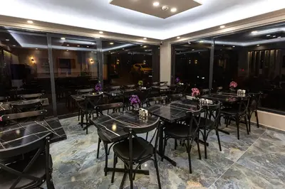 a dining room with black tables and chairs at Ria Suites Boutique Hotel in Istanbul