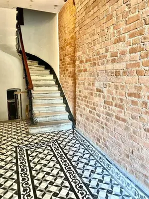 a brick wall with a staircase and a tiled floor at K&Y Apartments in Taksim 2 in Istanbul