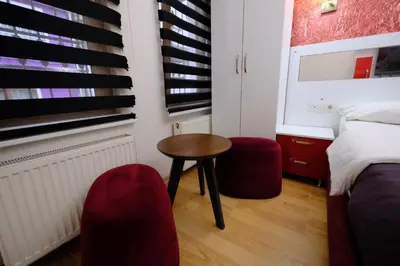 a bedroom with a bed and a table and chairs at ottogreensuit in Istanbul