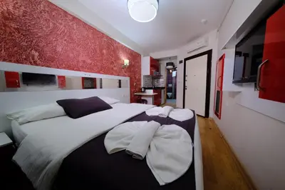 a bedroom with a large white bed with two pillows at ottogreensuit in Istanbul