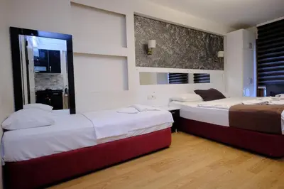 a bedroom with two beds and a window at ottogreensuit in Istanbul