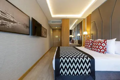 a hotel room with a bed in a room at Ramada Encore by Wyndham Istanbul Sisli in Istanbul