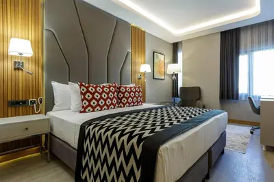 a hotel room with a large bed with red pillows at Ramada Encore by Wyndham Istanbul Sisli in Istanbul