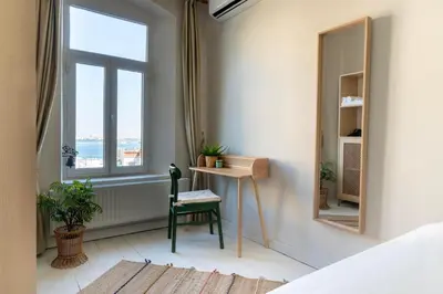 a bedroom with a desk and a window at Atlas Han Hotel in Istanbul