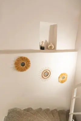 three circular mirrors on a wall with a shelf at Atlas Han Hotel in Istanbul
