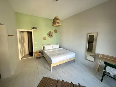a bedroom with a bed and a mirror in it at Atlas Han Hotel in Istanbul