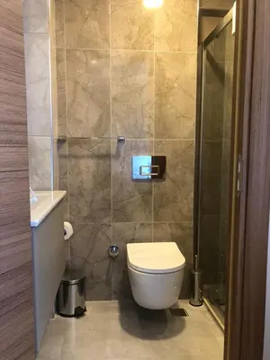 a bathroom with a toilet and a shower at Grand İska Palace in Istanbul