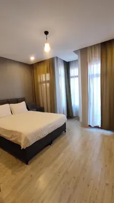 a bedroom with a large bed and some windows at Ore Pera Suites in Istanbul