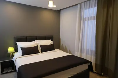 a bedroom with a large bed and a window at Ore Pera Suites in Istanbul