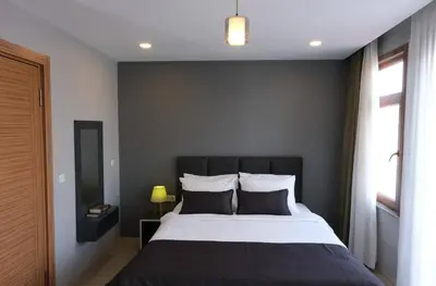 a bedroom with a large bed with two pillows at Ore Pera Suites in Istanbul