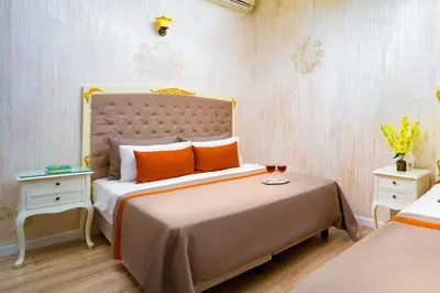 a bedroom with a large bed with orange pillows at Alhambra Apart Hotel in Istanbul