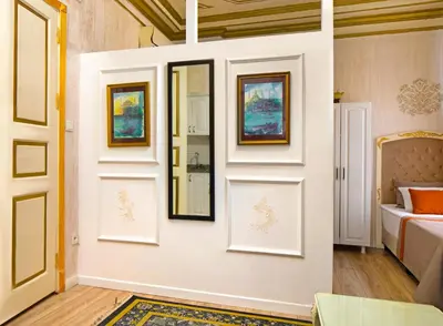 a room with paintings on the wall and a bed at Alhambra Apart Hotel in Istanbul