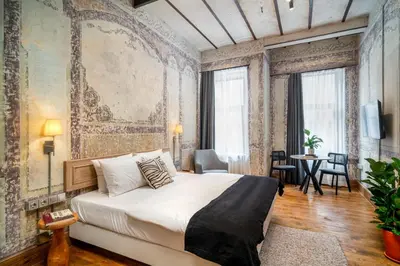 a bedroom with a large bed and a wall mural at Urban Quarters - Büklü Han in Istanbul