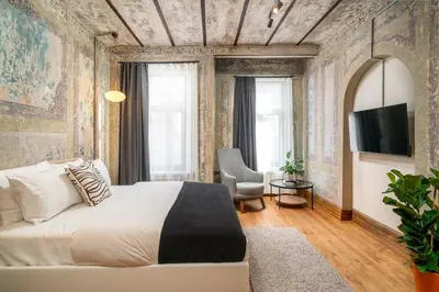 a bedroom with a large bed and a tv at Urban Quarters - Büklü Han in Istanbul