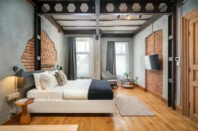 a bedroom with a bed and a brick wall at Urban Quarters - Büklü Han in Istanbul