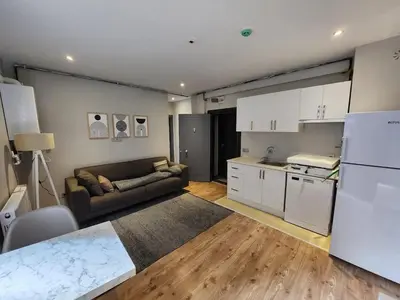 a living room with a couch and a kitchen at Remta Real Estate in Istanbul