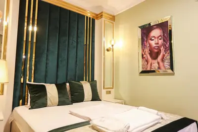 a hotel room with a bed with a poster of a woman at Whıte Moon Hotel Suites in Istanbul