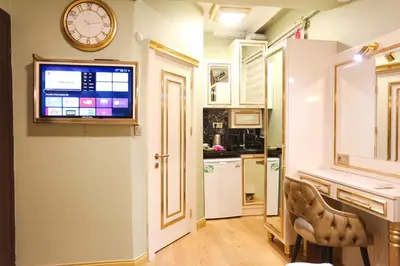 a kitchen with a clock on the wall and a chair at Whıte Moon Hotel Suites in Istanbul