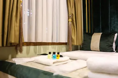 a room with two beds with towels and a window at Whıte Moon Hotel Suites in Istanbul