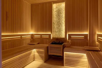 a sauna with wooden paneling and a window at Orient Occident Hotel Istanbul, Autograph Collection in Istanbul