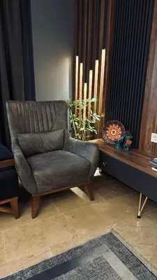 a living room with a chair and a table at Meridiani Taksim Hotel in Istanbul
